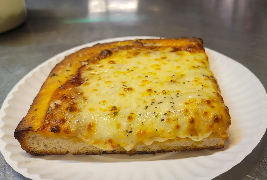 A thick square Sicilian cheese slice