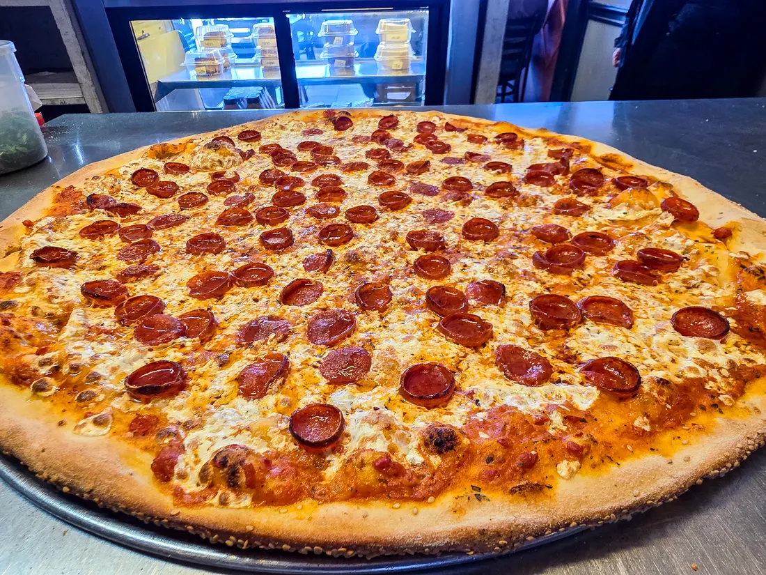 A whole pepperoni pizza hot from the oven