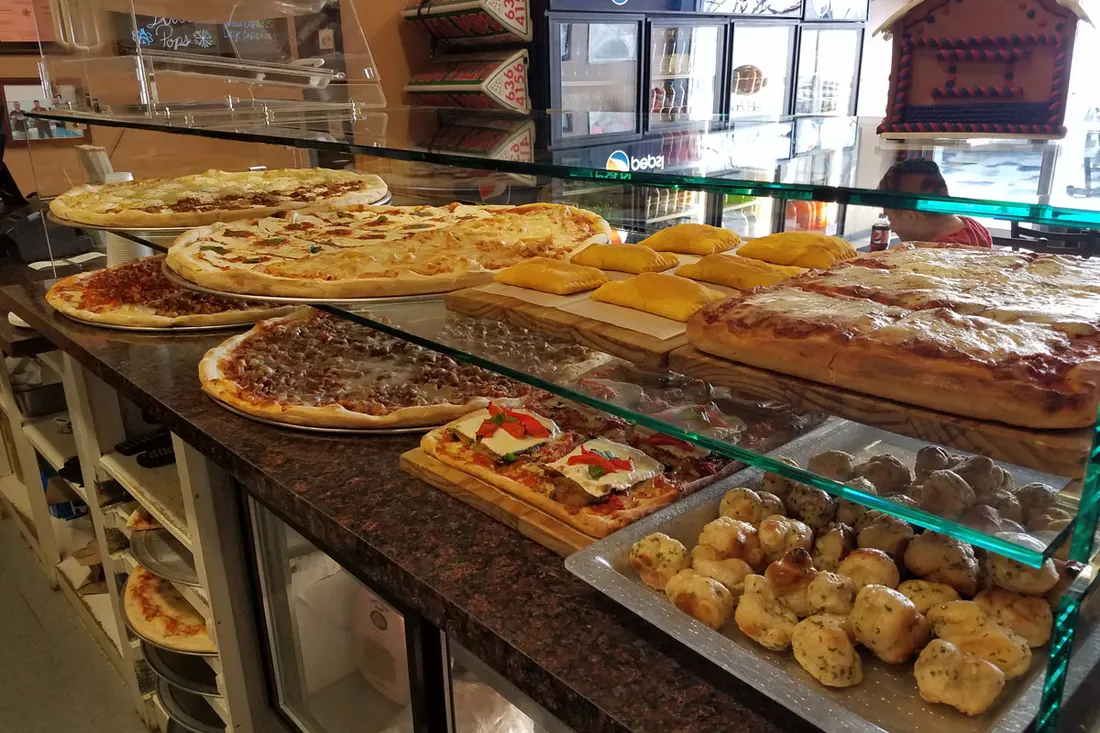 Pizzas and slices on display at the Little Pops counter